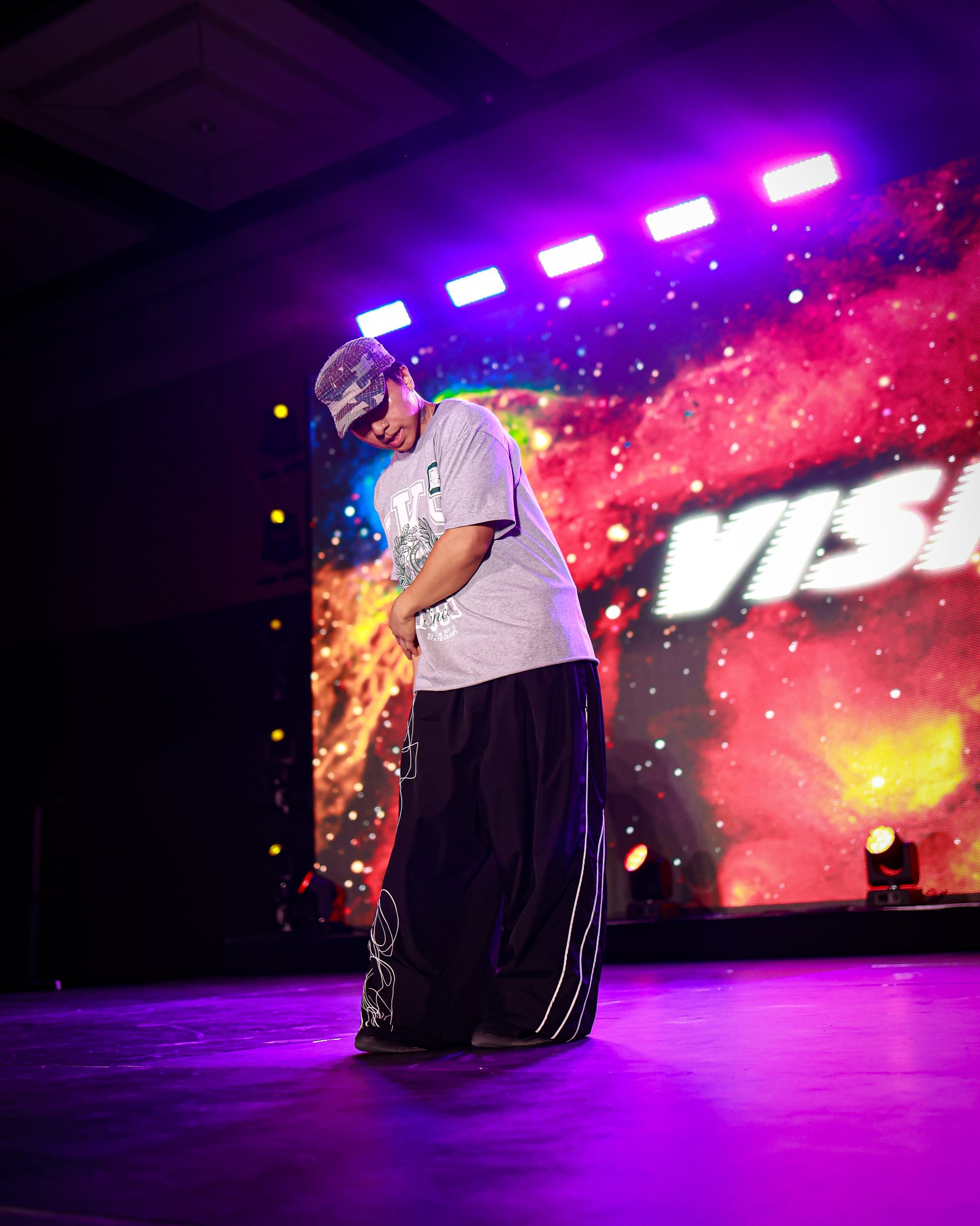 A solo performer owning the stage under LED visuals at VISION.